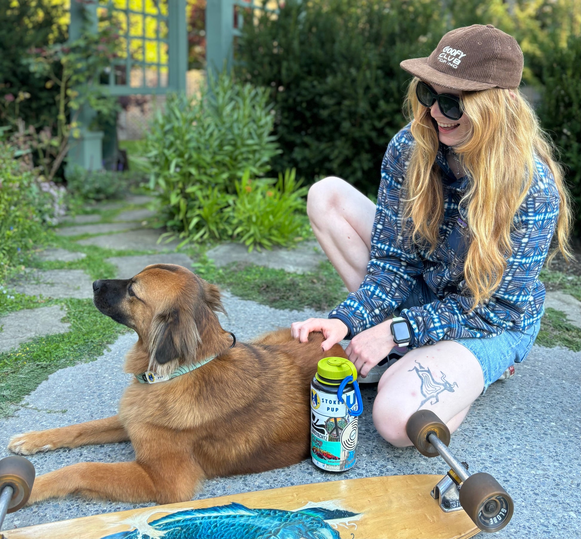 Girl playing with dog and dog. The dog is stoked on it's eco-friendly hemp easy clip dog collar.